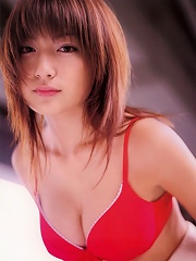 Sexy asian diva poses in a sizzling skin tight hot pink dress