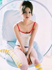 Long haired asian cutie having fun in a striped hot pink bikini