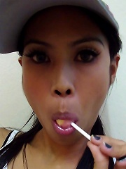 Hot THai babe named Ni licks and sucks a lolipop to tease us