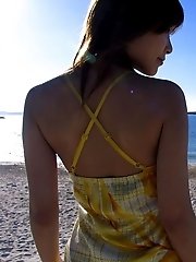Cute Asian model likes posing on the beach and showing her firm tits