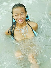Thai teen girl splashes around in the thailand sea